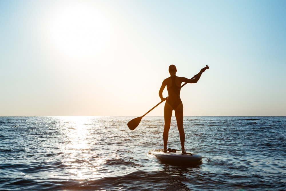 silhouette-young-beautiful-woman-surfing-sea-sunrise